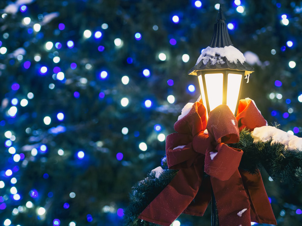 an outdoor lamp with festive decorations