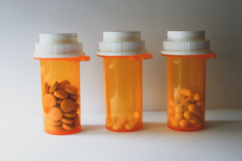 unmarked pill bottle containing various medications