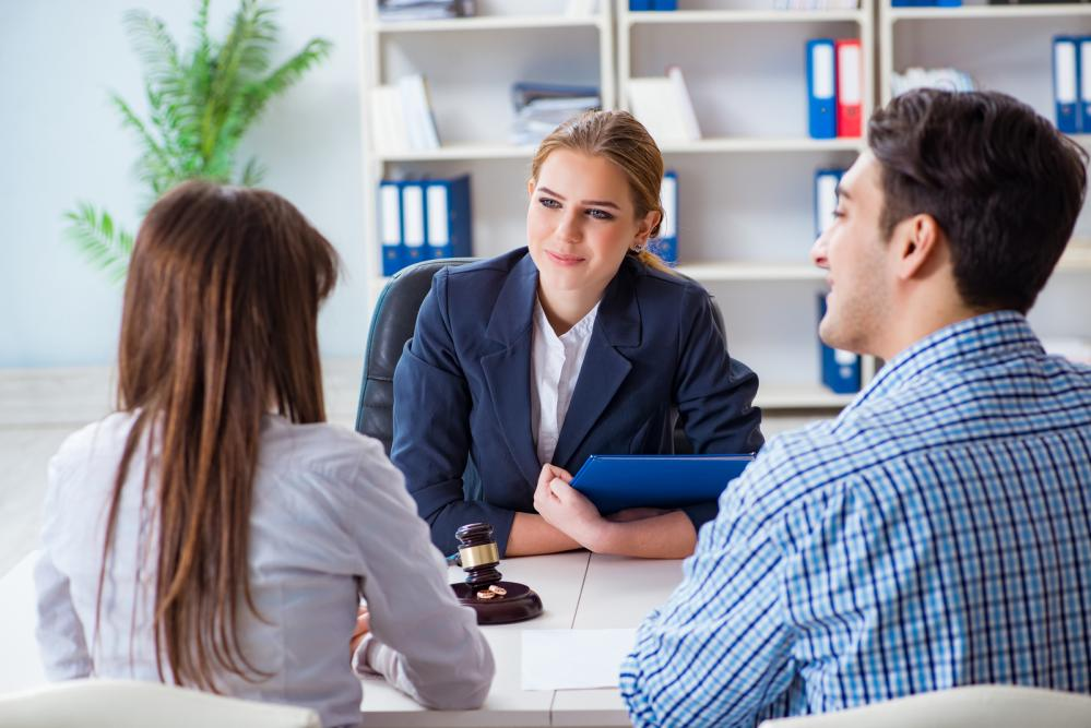 A young couple discussing marriage contracts with their lawyer