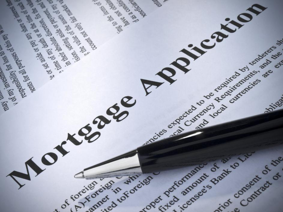 A mortgage application with a pen on top