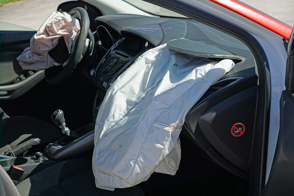 a car with deployed airbags following a rear-end collision