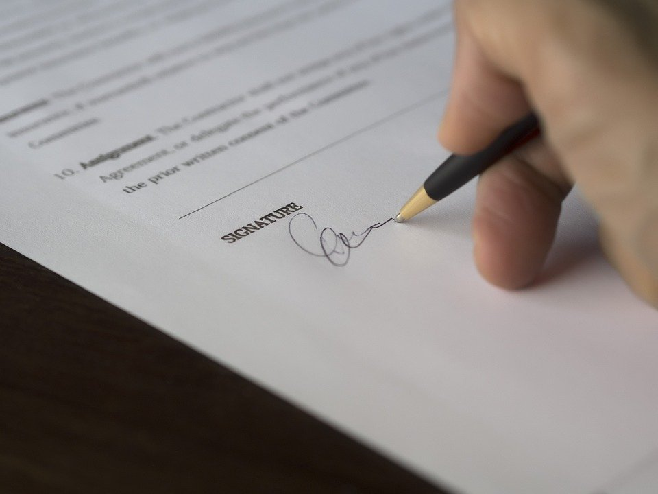 A buyer signing a real estate agreement