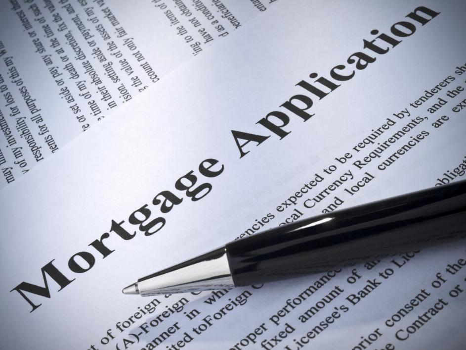 A pen lying on top of a mortgage application